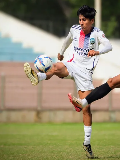 A dynamic action shot of our player executing a volley during the match.