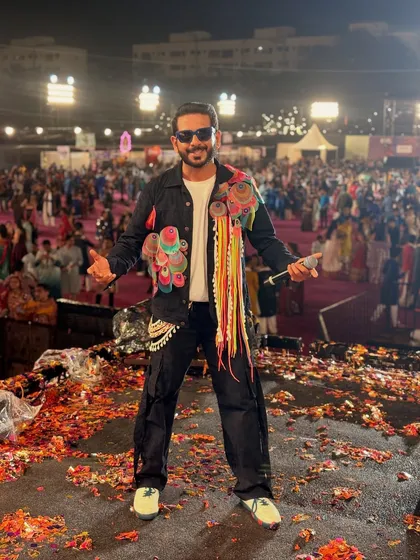 This is me in my element. On stage, mic in hand, with the energy of thousands of people celebrating at a Navratri festival. The confetti, the lights, the roar of the crowd, this is the electrifying atmosphere I live to create.