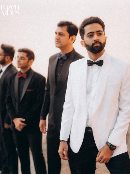 The groom and his groomsmen looking sharp. This is the modern version of a classic "boy band" shot, full of style and friendship.