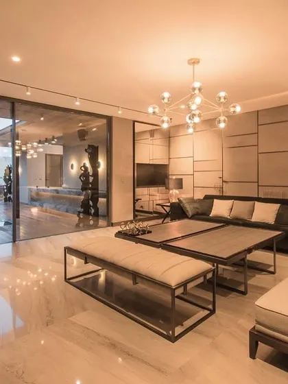 Soft grey tones are incredibly versatile for adding luxury and sophistication to living spaces. In this room, the grey color palette works wonderfully with metallic tones and sleek furniture, making the space feel open, light, and tranquil.