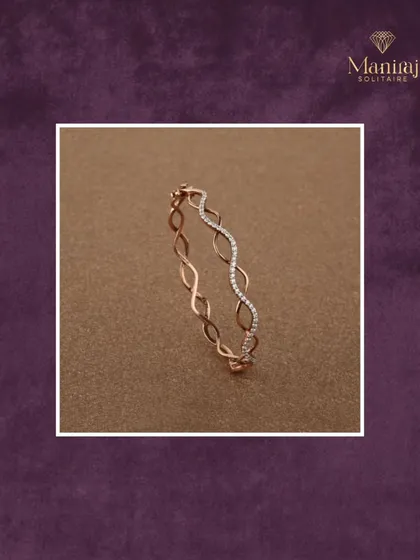 Subtle yet striking. This delicate rose gold bangle features a wave-like design with a section of pave diamonds, adding a touch of elegance to your everyday look.