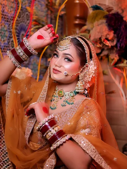 A playful and traditional pose, with the bride's hand raised in a graceful mudra.