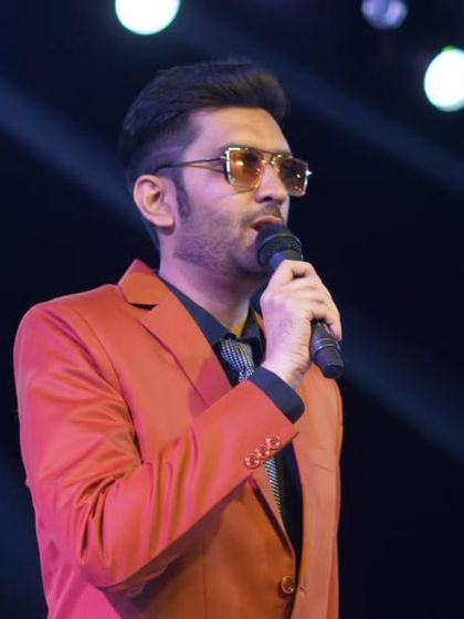 Hosting a wedding sangeet requires a different kind of energy. Here I am, under the spotlight, weaving a story of joy and celebration.