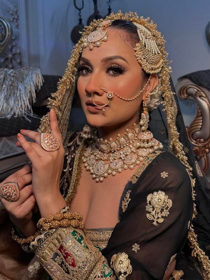 A powerful and royal Muslim bridal look in black and gold. This is for the bride who wants to make a bold and unforgettable statement on her wedding day.