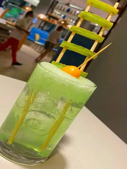 A refreshing green mocktail with a creative cucumber garnish. We believe that even the simplest drinks should be presented with a touch of creativity.