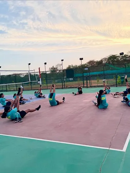 Synchronized stretching under the evening sky. Discipline and routine are key components of our training regimen.