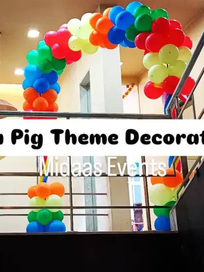 A colorful balloon archway for the Peppa Pig party, guiding guests up the stairs. The bright, primary colors perfectly match the fun and cheerful vibe of the theme.