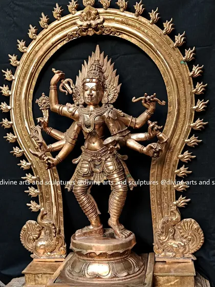 Here is our depiction of Bhadrakali, a fierce and protective form of the great Goddess. This 32-inch Panchaloha sculpture, framed by a traditional Prabhavali arch, captures her dynamic energy and intricate details, from the weapons in her hands to the cosmic dance of her posture.