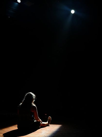 A lone actor on stage during a lighting check for "Gretel."