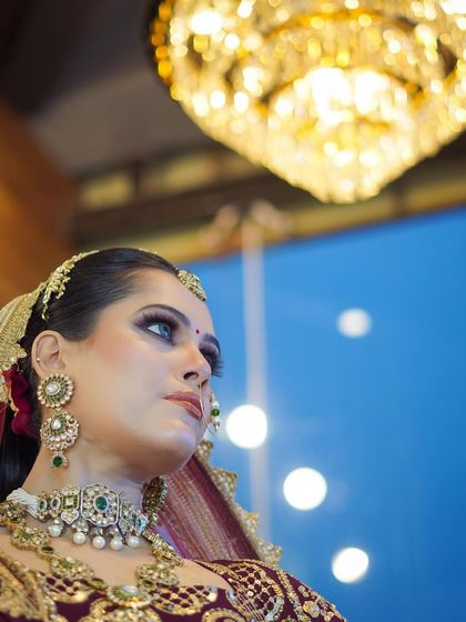 An artistic shot capturing the elegance of the bride. The makeup is designed to look regal and sophisticated, fitting for the most important day of her life.