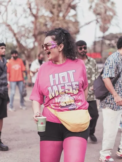 Capturing the pure joy of the festival experience. A happy client with a custom purple glitter design, living her best life at DGTL music festival.