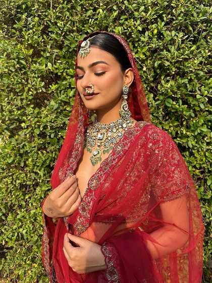 A sun-kissed shot of a bride, her sleek bun adding to the regal look.