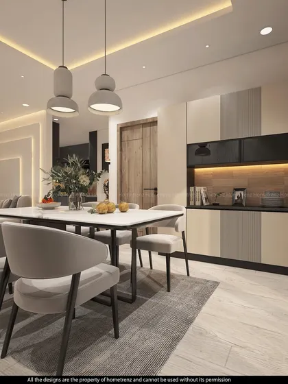 A view of the dining table and the adjacent crockery unit. The pendant lights and neutral color palette create a calm and elegant atmosphere.