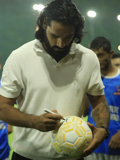 Sandesh Jhingan signing a football for our young, aspiring players during his visit.