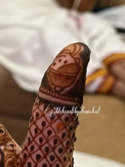 A tiny, cute monkey face drawn on the fingertip for a baby shower mehendi. It's these little details that bring so much joy!