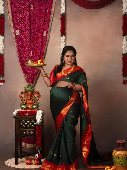 A solo portrait of the mama-to-be holding a traditional thali, looking radiant and full of grace.