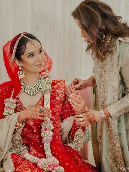 A mother adjusting her daughter's outfit during the ceremony, a small act of love.