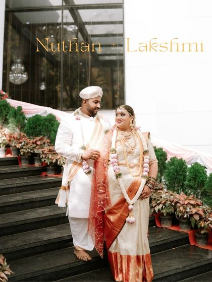 A classic portrait of a couple on a grand staircase. Their traditional Reddy wedding attire and the formal setting create an image of timeless elegance.
