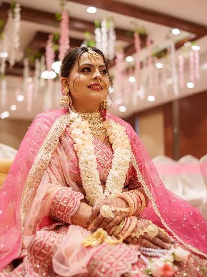 The bride during her wedding ceremony, looking serene and beautiful. The makeup is soft and radiant, perfect for a daytime event.