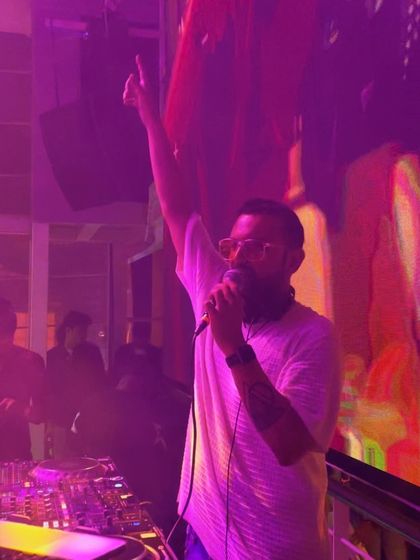 One hand up, commanding the room. This is a classic Fikticious pose, full of energy and confidence.