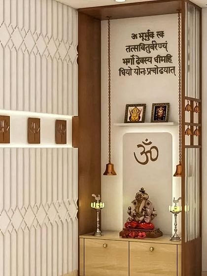 This pooja unit combines modern design with traditional elements. It features a Gayatri Mantra inscription, hanging temple bells, and a clean, light-wood cabinet for storing pooja essentials.