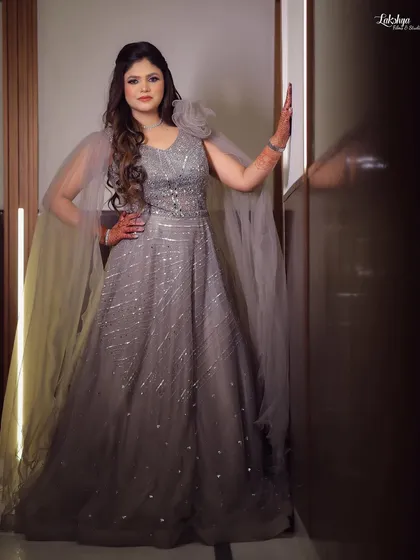 A stunning portrait of the bride in her caped gown. This shot captures her confidence and elegance on her engagement day.