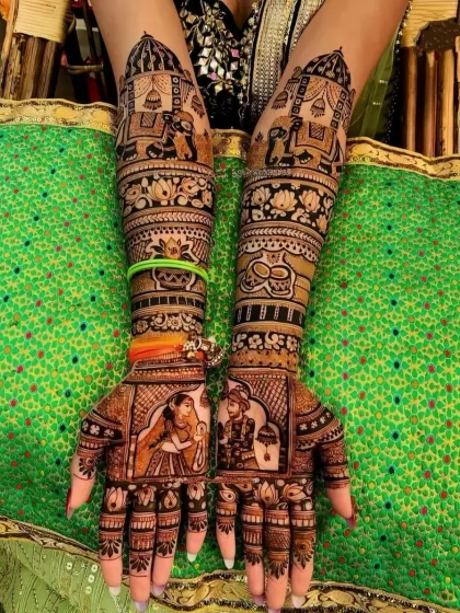 A classic bridal design with bride and groom portraits on the palms, and doli and elephant motifs on the arms.