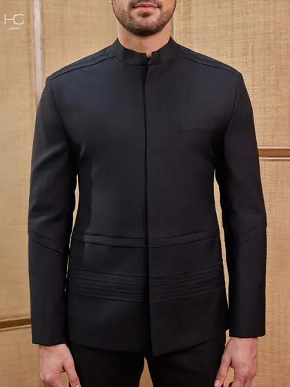 Another look at the minimalist bandhgala, this time focusing on the subtle pleated details at the waist that provide structure and a unique design element.