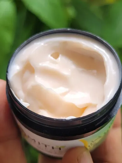 Look at the rich, creamy texture of my Vitamin C Cream. I hold it up to show you it's freshly made and packed with goodness. This cream is designed to help prevent sun damage, improve the appearance of dark spots, and give your skin a healthy glow.