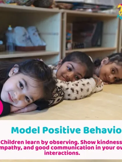 Three girls share a quiet, happy moment. Children learn positive behavior by observing kindness and empathy in their interactions with peers.