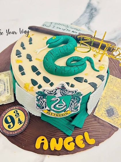 Slytherin pride, baked to perfection. This Harry Potter cake features the house crest, a fondant snake, and the Marauder's Map.