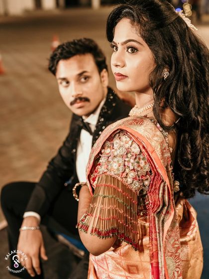 A stylish portrait of the couple at their reception, with the bride looking over her shoulder at the camera.