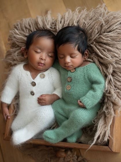 Another angle of these two sweethearts, nestled together in a rustic wooden box. The textures of the knit outfits and the fuzzy liner add so much warmth.