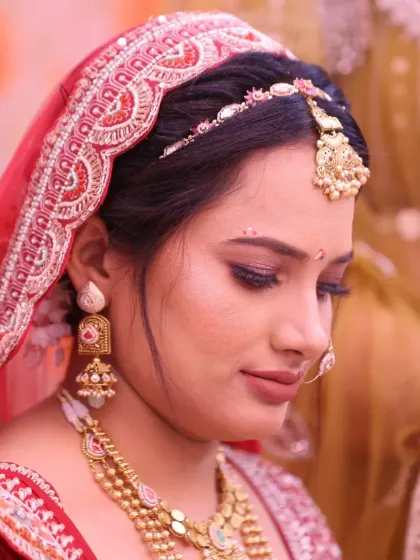 A close-up showcasing the soft, blended eyeshadow and perfectly shaped brows. The traditional bindi and maang tikka complete this classic Gujarati bridal look.