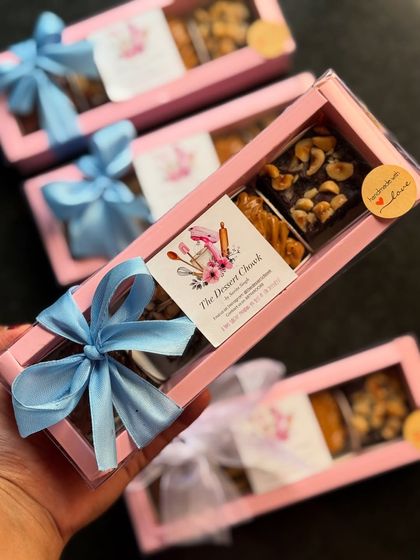 My assorted brownie bite boxes with blue ribbons, ready for Rakhi gifting. A sweet treat for a sweet bond.