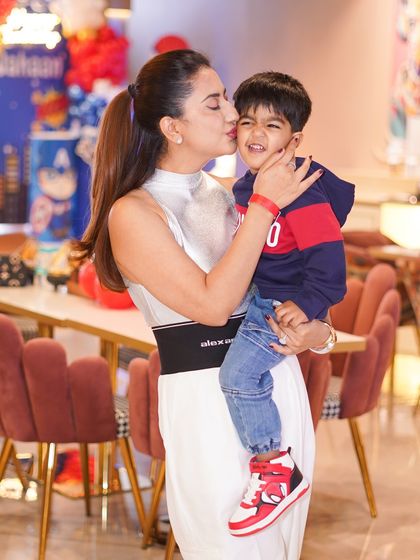 A mother's loving kiss for the birthday boy. These are the precious, candid moments we strive to create at every event.