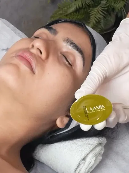 Using a gentle, organic L'aamis product during a facial. I believe in using quality ingredients that are kind to your skin while delivering effective results.