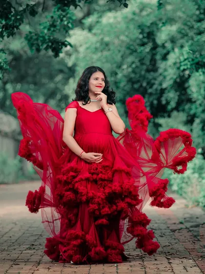 A stunning shot of our red ruffled gown in motion. The layers of tulle create a beautiful "flying" effect, perfect for a dramatic and vibrant maternity photo.