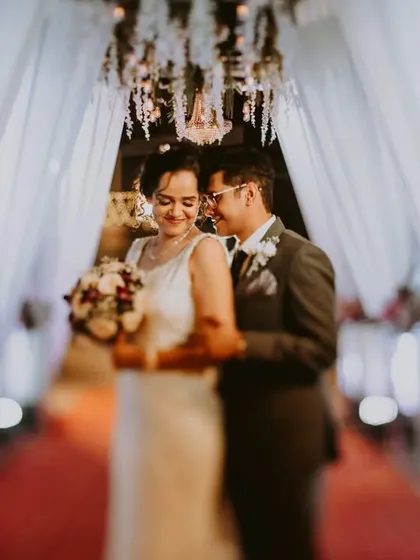 A quiet, stolen moment just before entering their wedding reception. Using a special lens, I created a soft, dreamy focus that enhances the intimacy of their embrace.