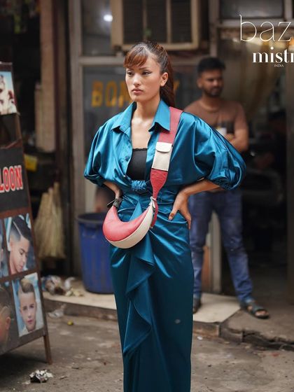 Our color-blocked Selena in red and white, styled against the vibrant backdrop of an old Delhi market. It’s a modern bag that feels at home in a traditional landscape.