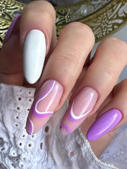 A chic design combining solid purple and white nails with abstract purple and white line art on a nude base.