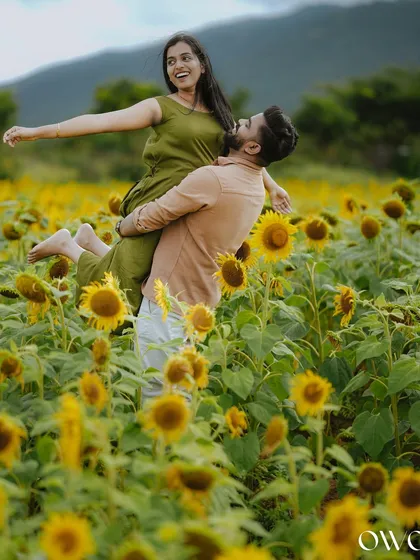 Your love story should be full of joy and spontaneity. We capture these playful, unscripted moments during pre-wedding shoots, like this one in a vibrant sunflower field, creating memories that are as fun as they are beautiful.