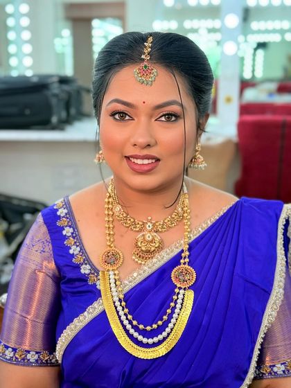 A happy and confident bride to be. Her skin is glowing, and the makeup enhances her features without looking heavy, perfect for her engagement ceremony.