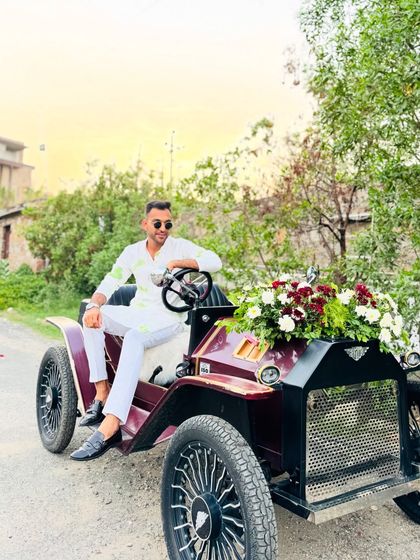 Posing with the vintage car before the baraat begins. It's these unique details that make a wedding stand out.