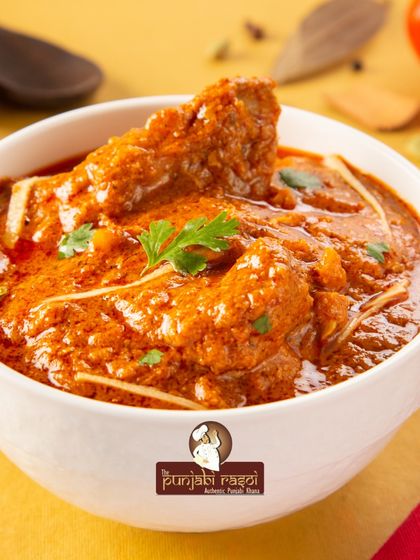 The taste of happiness and India. This bowl of rich chicken curry represents the comforting and flavorful essence of our cuisine.