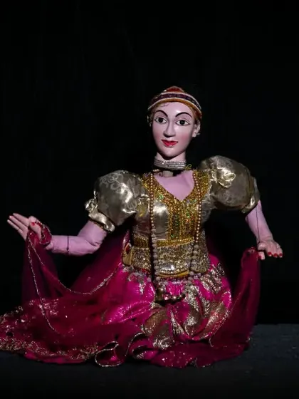 A stunningly ornate marionette from the 'Traditional String Puppet Show from Sri Lanka'. The costume and features reflect the rich cultural heritage of Sri Lankan puppetry, a tradition we are honored to present.