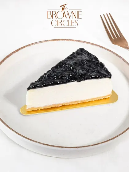 A classic done right. Our baked Blueberry Cheesecake features a creamy, rich cheesecake filling on a crisp biscuit base, topped with a generous layer of vibrant blueberry compote. It’s a perfect balance of sweet and tangy.