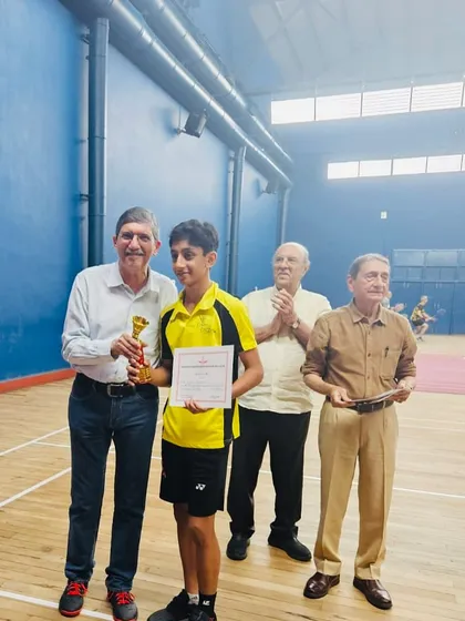 Presenting the trophy to Zehn Masani for one of his six victories at the FOZAWAC tournament. A proud moment for both student and coach.