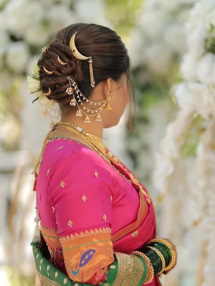 A beautiful view of the bride's hairstyle, featuring a twisted bun and a traditional crescent accessory.