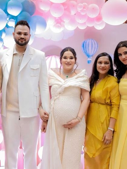 A beautiful portrait of the parents-to-be with their family. The pastel balloon backdrop provides a soft and lovely setting for these cherished photos.